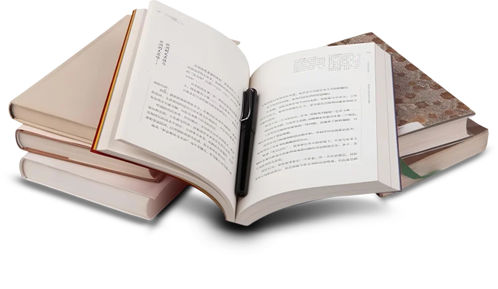 Open book with pen resting on a stack of books